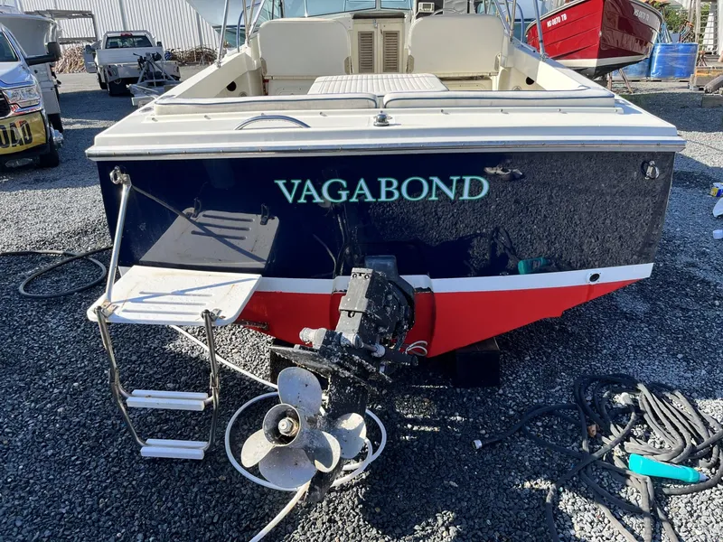 Slide: The Image of 2001 Limestone 24' Express Cruiser "Vagabond" with outboard motor and swim ladder. - 3