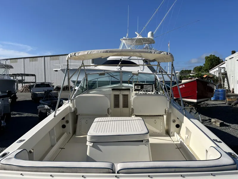 Slide: The Image of 2001 Limestone 24' Express Cruiser in a boatyard, featuring spacious seating and canopy. - 7
