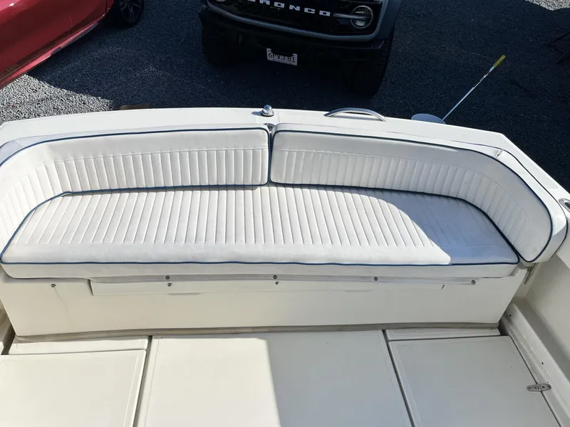 Slide: The Image of White cushioned seating on 2001 Limestone 24' Express Cruiser boat deck. - 9