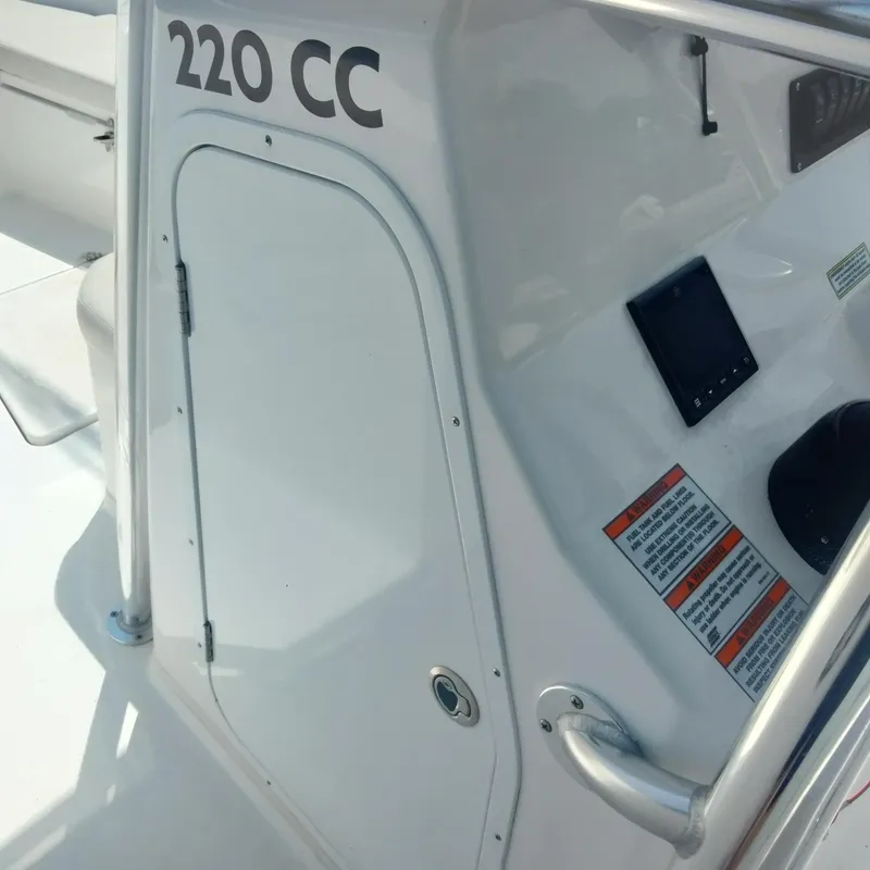 Slide: The Image of 2024 Aquasport 2200 Center Console boat dashboard and side view. - 11