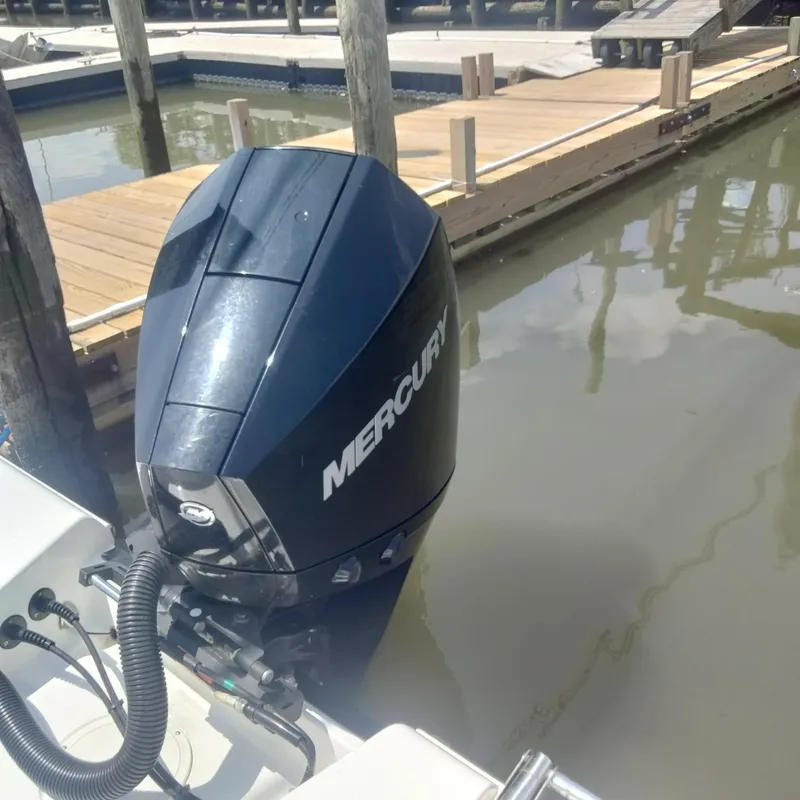 Slide: The Image of 2024 Aquasport 2200 Center Console with Mercury outboard engine at dock. - 3