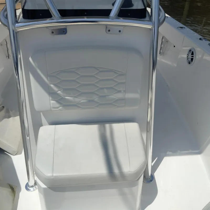 Slide: The Image of 2024 Aquasport 2200 Center Console boat seat with stainless steel frame and white upholstery. - 7