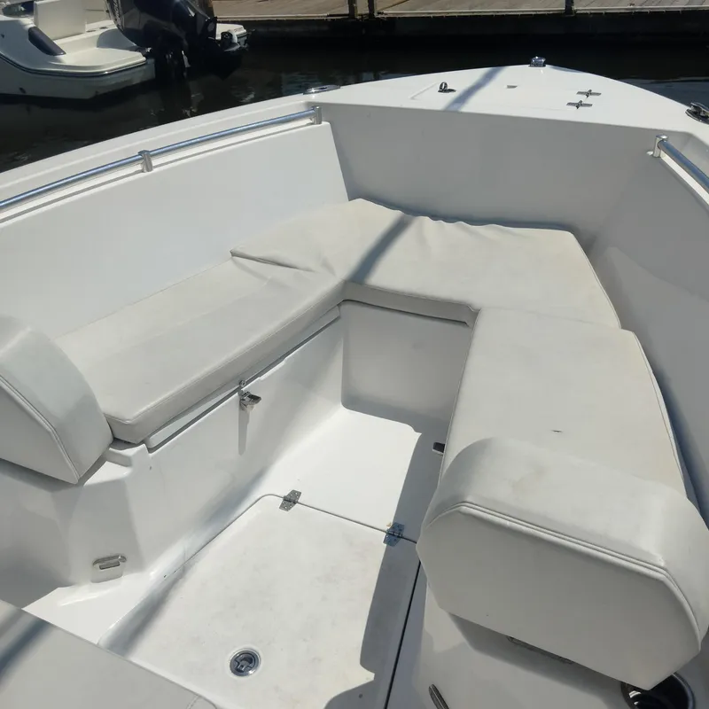 Slide: The Image of 2024 Aquasport 2200 Center Console boat interior with cushioned seating. - 9