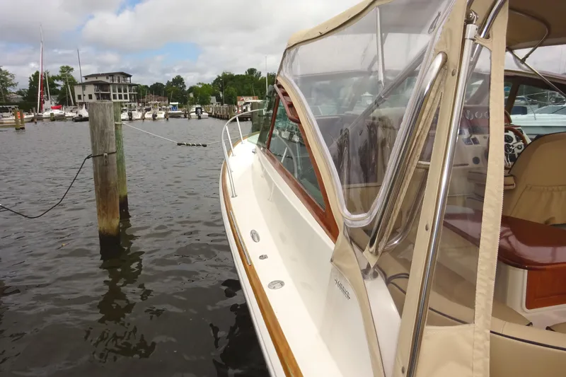 Slide: The Image of 2009 Hunt Yachts Harrier 29 docked at a marina, showcasing elegant design and clear canopy. - 14