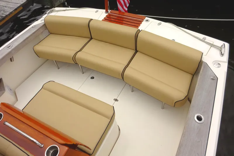 Slide: The Image of 2009 Hunt Yachts Harrier 29 interior with beige seating and wooden accents. - 16