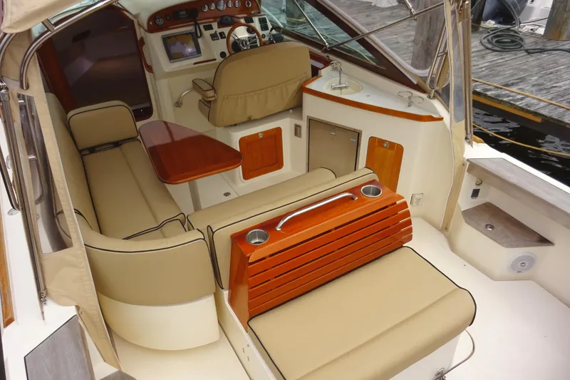 Slide: The Image of 2009 Hunt Yachts Harrier 29 interior with beige seating and wooden accents. - 17