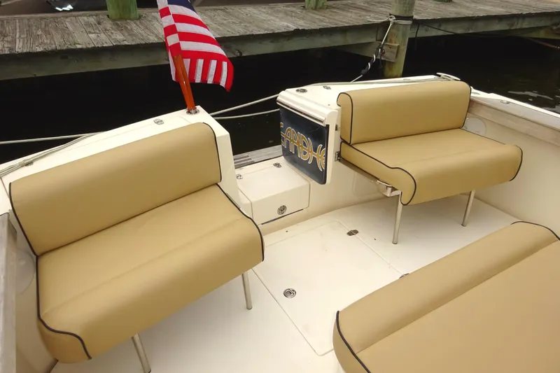 Slide: The Image of 2009 Hunt Yachts Harrier 29 boat interior with tan seating and American flag. - 18