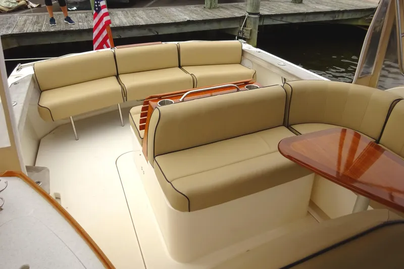 Slide: The Image of 2009 Hunt Yachts Harrier 29 interior with beige seating and wooden table. - 19
