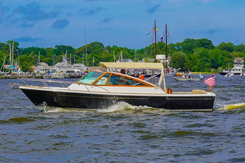 Slide: The Image of 2009 Hunt Yachts Harrier 29 cruising on a scenic waterway with American flag. - 2