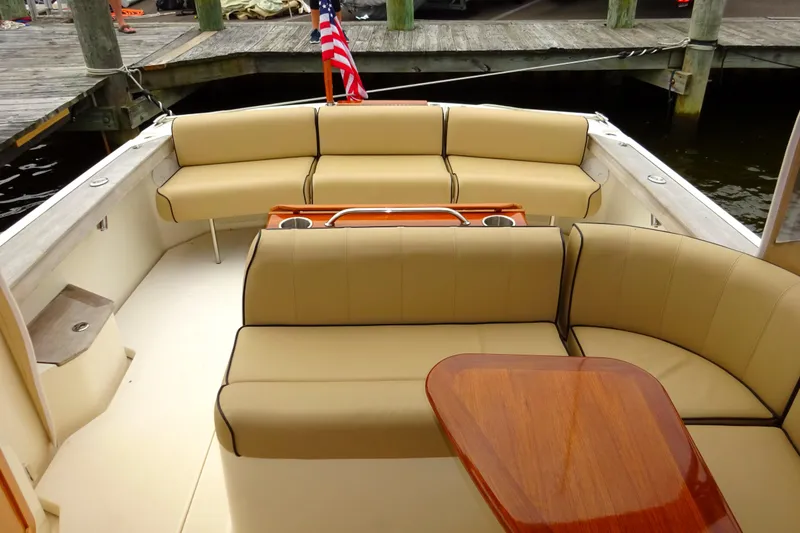 Slide: The Image of 2009 Hunt Yachts Harrier 29 interior with beige seating and wooden table. - 20