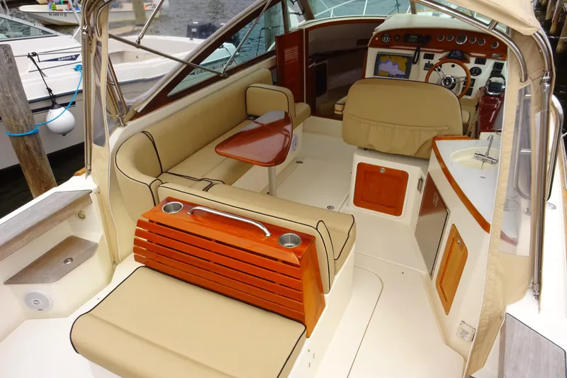 Slide: The Image of 2009 Hunt Yachts Harrier 29 interior with beige seating and wooden accents. - 24