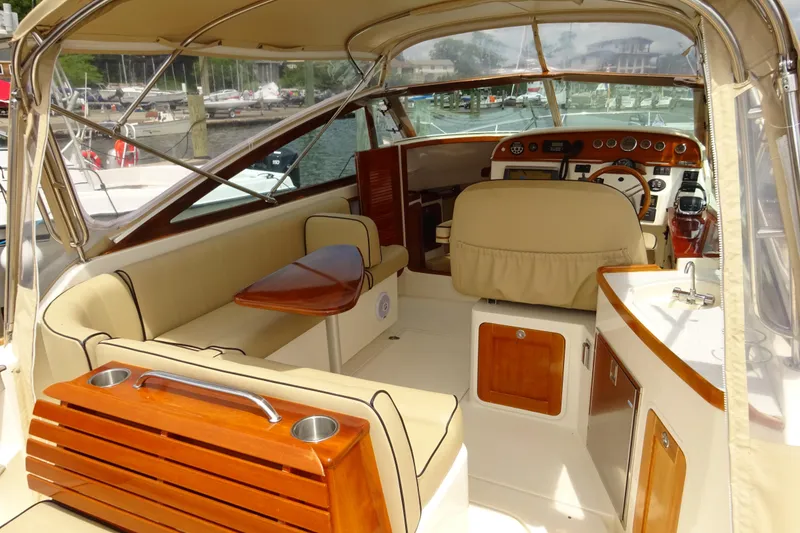Slide: The Image of 2009 Hunt Yachts Harrier 29 interior with beige seating and wooden accents. - 26