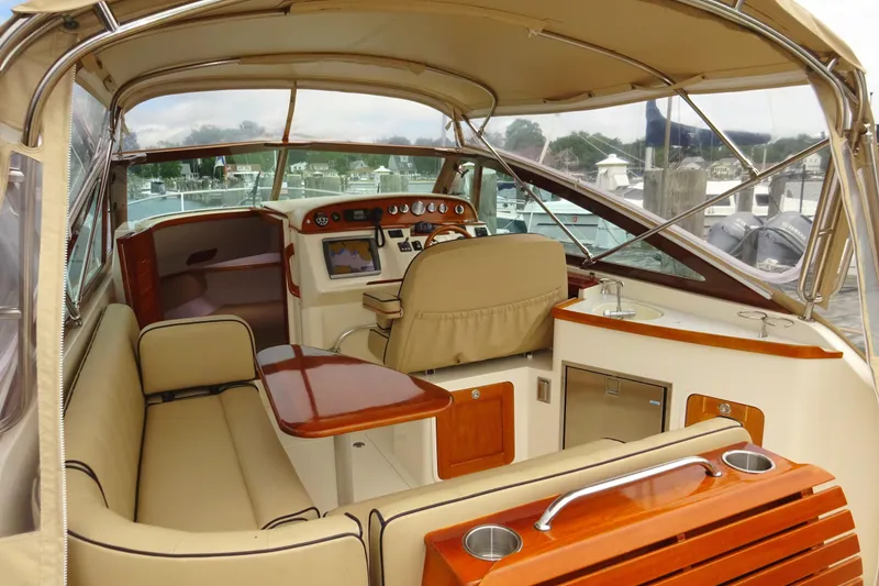 Slide: The Image of 2009 Hunt Yachts Harrier 29 interior with beige seating and wooden accents. - 27
