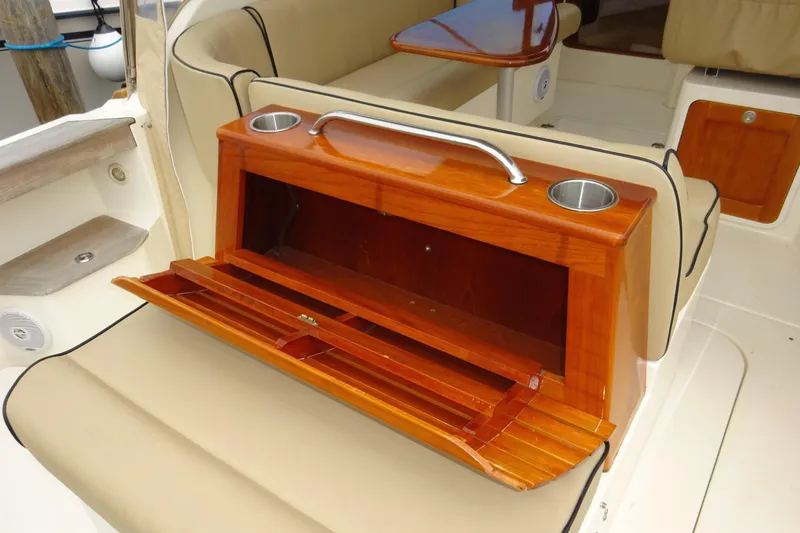 Slide: The Image of 2009 Hunt Yachts Harrier 29 interior with wooden storage and cup holders. - 28