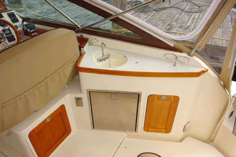 Slide: The Image of 2009 Hunt Yachts Harrier 29 interior with sink and wooden cabinetry. - 31