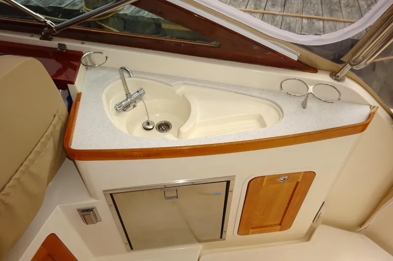 Slide: The Image of 2009 Hunt Yachts Harrier 29 interior with sink and storage cabinets. - 32