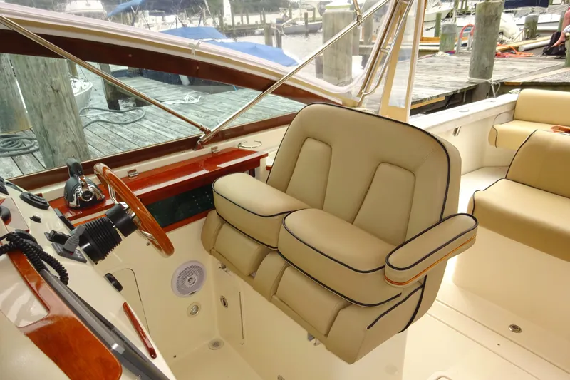 Slide: The Image of 2009 Hunt Yachts Harrier 29 interior with beige seating and wooden accents. - 33