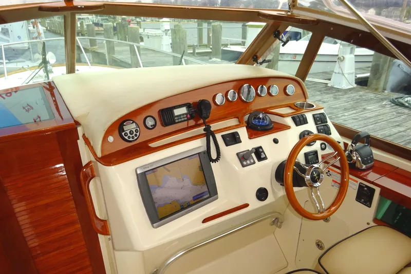 Slide: The Image of 2009 Hunt Yachts Harrier 29 helm with navigation equipment and wooden accents. - 36
