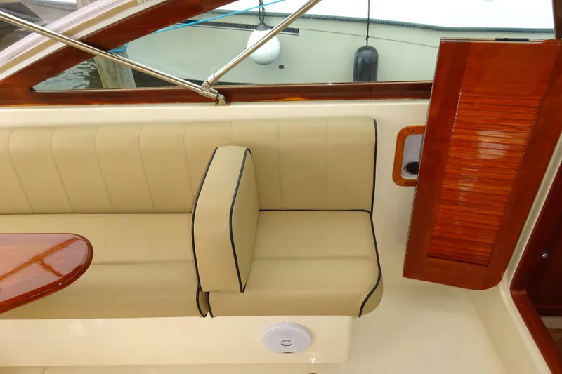 Slide: The Image of 2009 Hunt Yachts Harrier 29 interior with beige seating and wooden accents. - 39