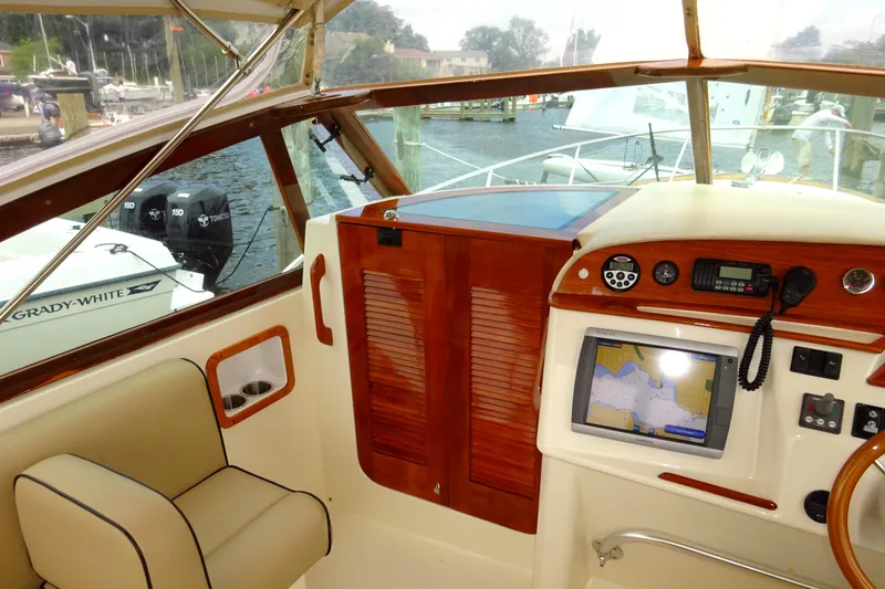 Slide: The Image of 2009 Hunt Yachts Harrier 29 cockpit with navigation equipment and wooden accents. - 40