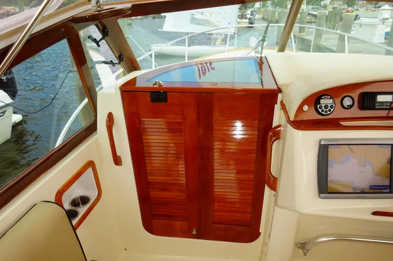 Slide: The Image of 2009 Hunt Yachts Harrier 29 helm with wooden cabinetry and navigation equipment. - 42