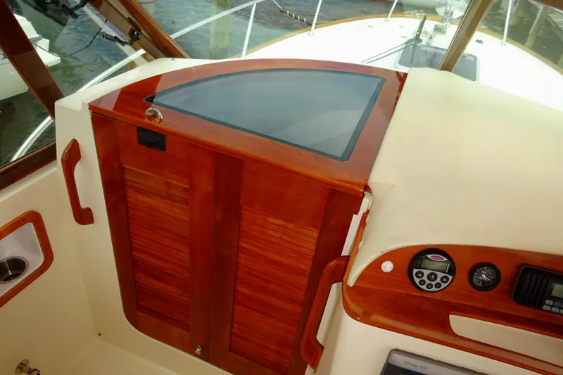 Slide: The Image of 2009 Hunt Yachts Harrier 29 cockpit with wooden paneling and control instruments. - 43