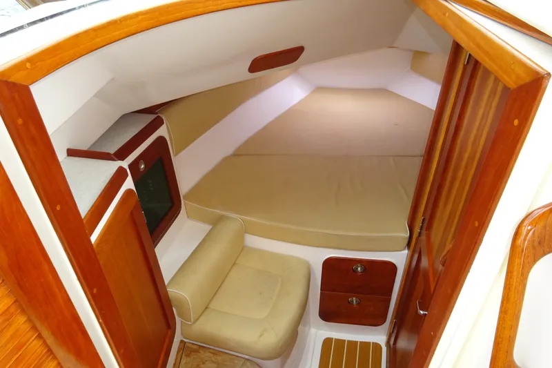 Slide: The Image of 2009 Hunt Yachts Harrier 29 cabin interior with wood finish and beige seating. - 45