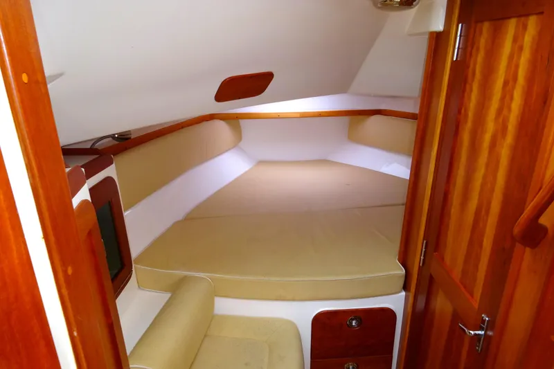Slide: The Image of 2009 Hunt Yachts Harrier 29 cabin interior with wooden finish and cozy seating. - 46