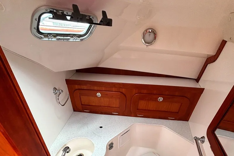 Slide: The Image of 2009 Hunt Yachts Harrier 29 interior with wooden cabinets and a small sink. - 49