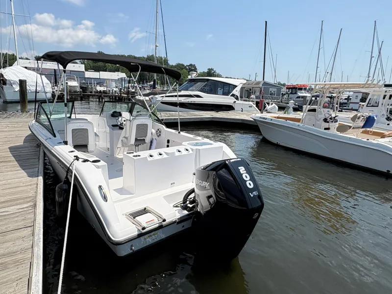 Slide: The Image of 2023 Aquasport 2200 Dual Console boat docked at marina with Mercury engine. - 5