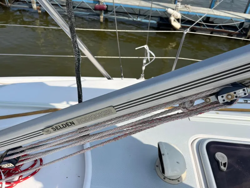 Slide: The Image of Selden Rodkicker on 2000 Hunter 340 sailboat, docked by the water. - 13