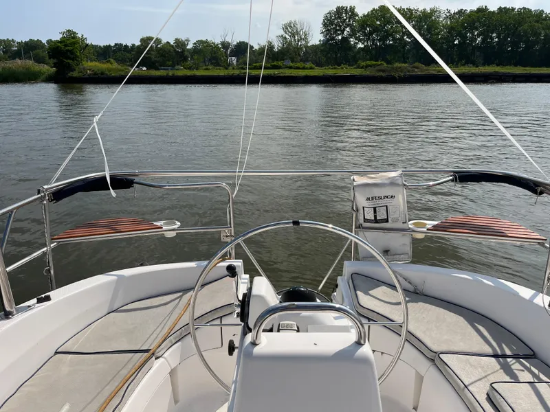 Slide: The Image of Cockpit view of a 2000 Hunter 340 sailboat on calm water. - 18