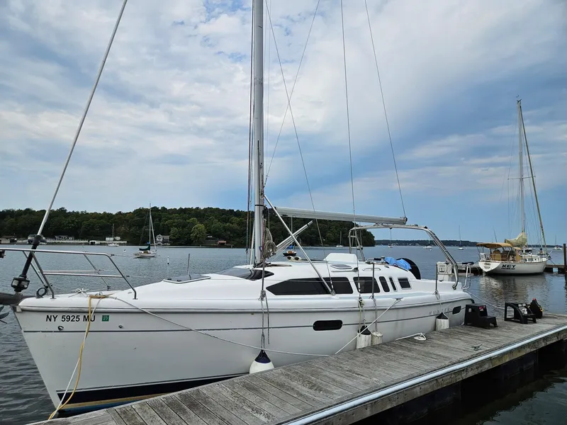 Slide: The Image of Sailboat docked at marina, Hunter 340 model, 2000, under cloudy sky. - 2