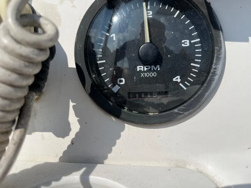 Slide: The Image of Close-up of a Hunter 340 tachometer showing RPM and odometer reading. - 21