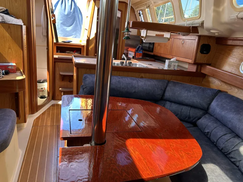 Slide: The Image of Interior of 2000 Hunter 340 sailboat with wood finish and cozy seating area. - 27