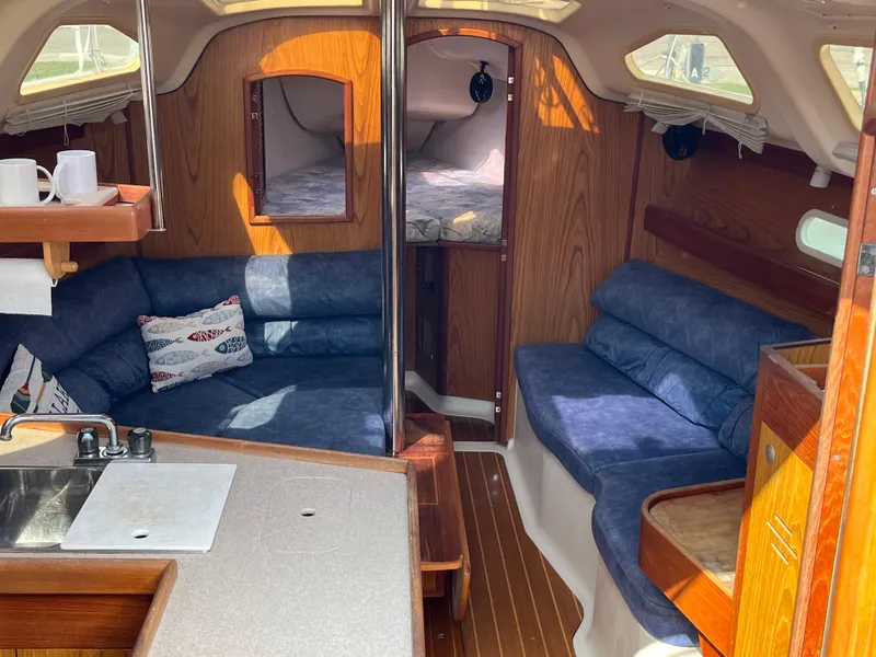 Slide: The Image of Interior of 2000 Hunter 340 sailboat with cozy seating and wooden finishes. - 28