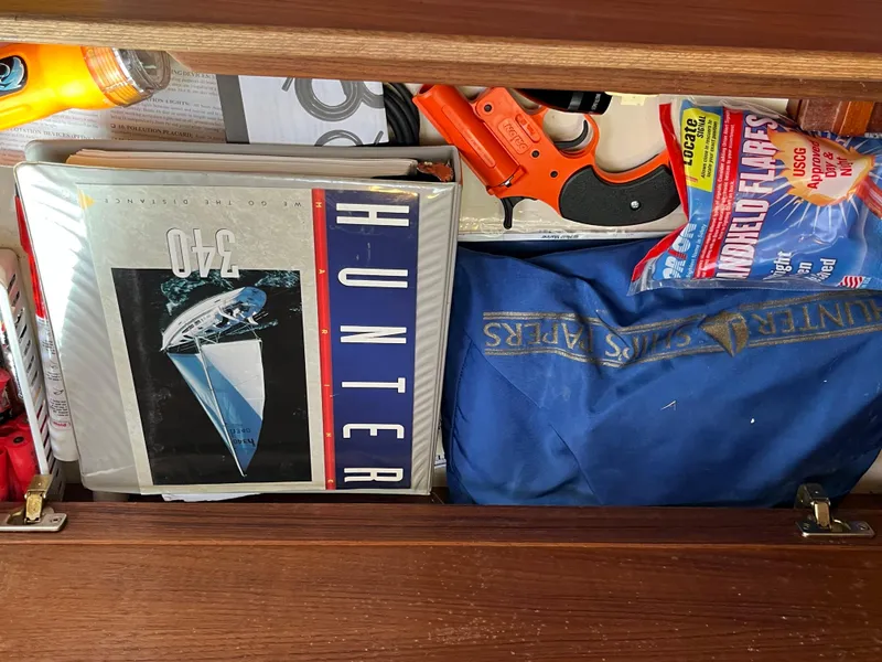 Slide: The Image of Drawer containing Hunter 340 manual, flares, and safety equipment. - 32