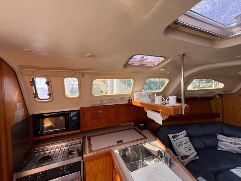 Slide: The Image of Interior of 2000 Hunter 340 sailboat with kitchen, seating, and skylights. - 35