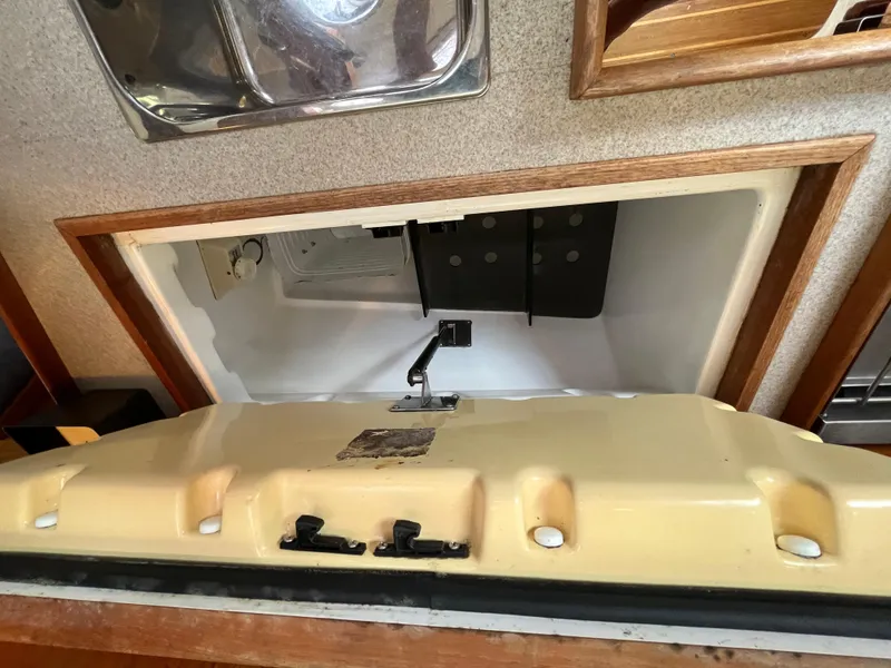 Slide: The Image of Open refrigerator in 2000 Hunter 340 yacht galley, showcasing interior storage space. - 41