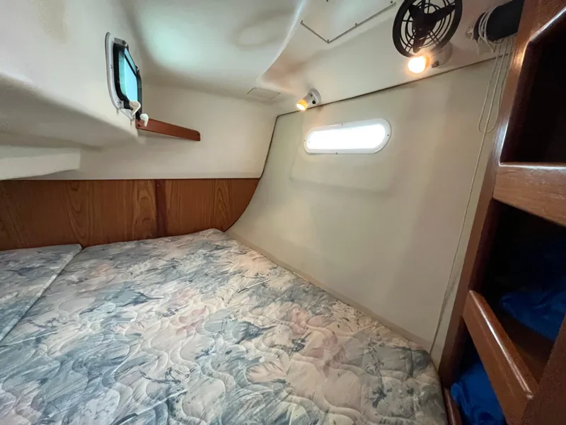 Slide: The Image of Cozy cabin interior of 2000 Hunter 340 sailboat with bed and porthole. - 43