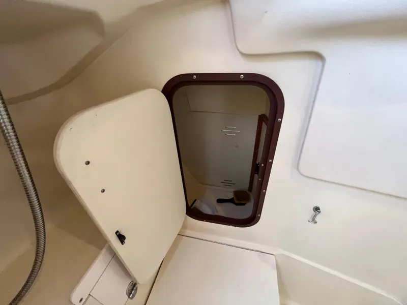 Slide: The Image of Interior view of a 2000 Hunter 340 sailboat, featuring an open storage compartment. - 48