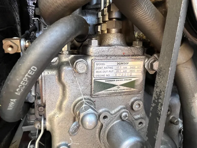 Slide: The Image of Yanmar 3GM30F diesel engine in a 2000 Hunter 340 sailboat, showing specifications plate. - 50