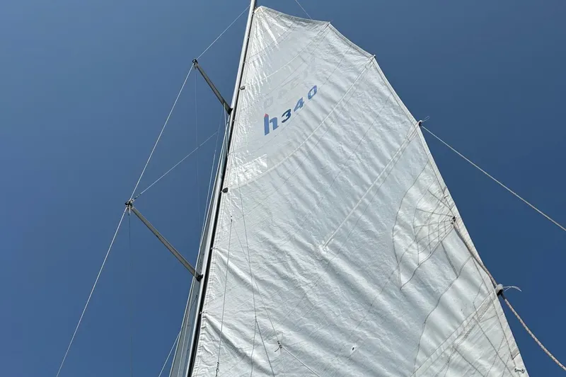 Slide: The Image of Sail of a 2000 Hunter 340 yacht against a clear blue sky. - 7
