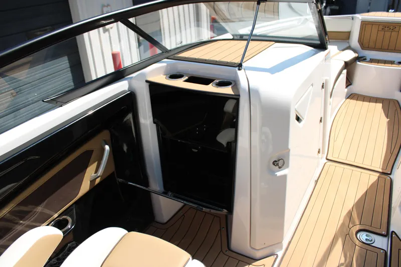 Slide: The Image of 2022 Yamaha Boats 252S interior with sleek design and wood-style flooring. - 10