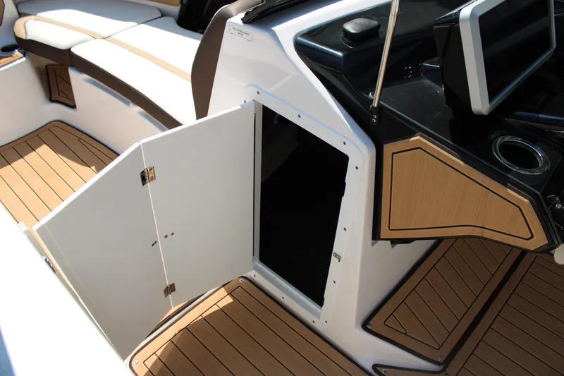 Slide: The Image of 2022 Yamaha Boats 252S interior with open storage compartment and sleek seating. - 12