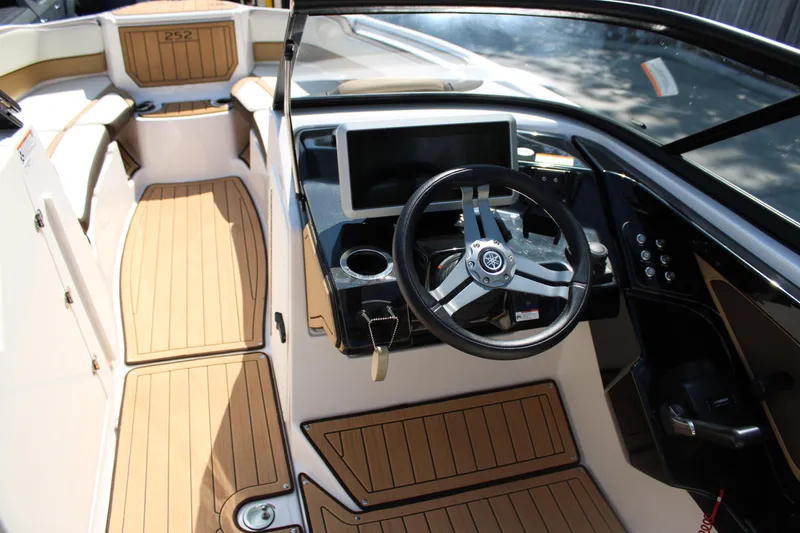 Slide: The Image of 2022 Yamaha Boats 252S cockpit with steering wheel and modern dashboard. - 13