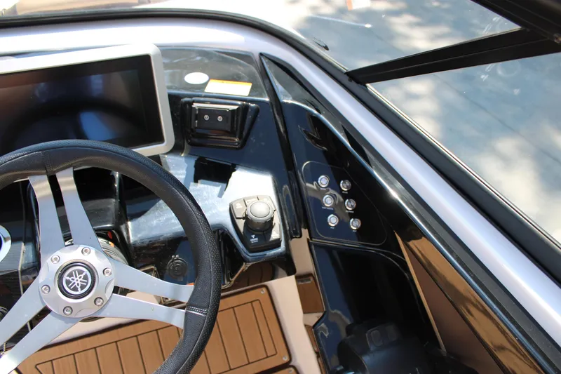 Slide: The Image of 2022 Yamaha Boats 252S dashboard with steering wheel and control panel. - 14