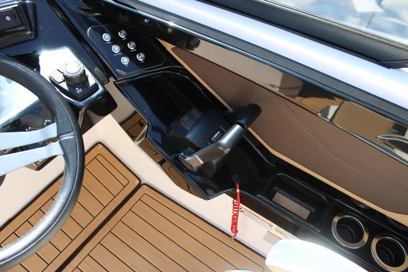 Slide: The Image of 2022 Yamaha Boats 252S cockpit with steering wheel, controls, and wood-style flooring. - 15