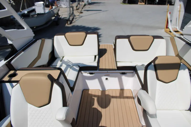 Slide: The Image of 2022 Yamaha Boats 252S interior with beige and white seating, showcasing luxury design. - 16