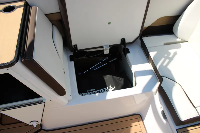 Slide: The Image of 2022 Yamaha Boats 252S storage compartment with open seat and visible interior. - 18